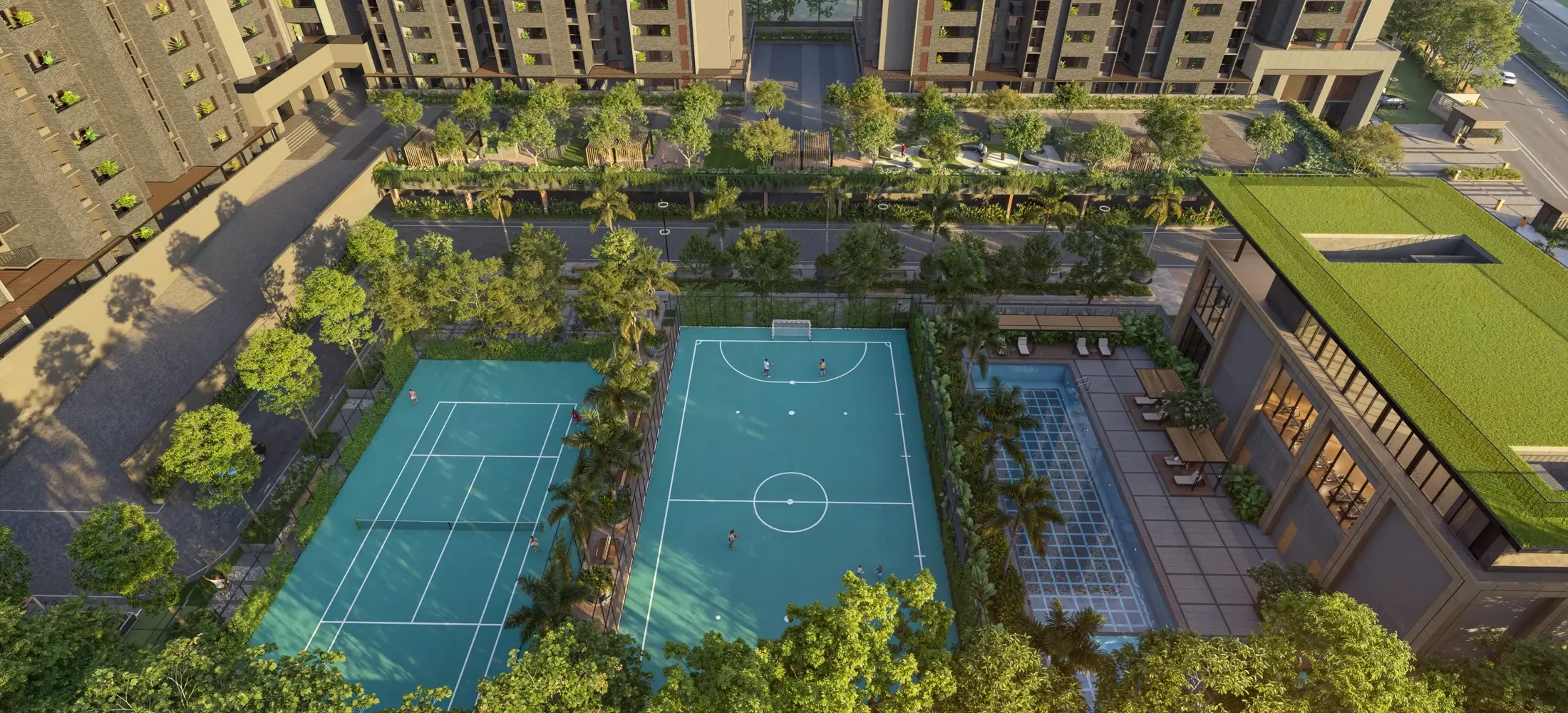 An aerial view of tennis, futsal and play courts set among trees.